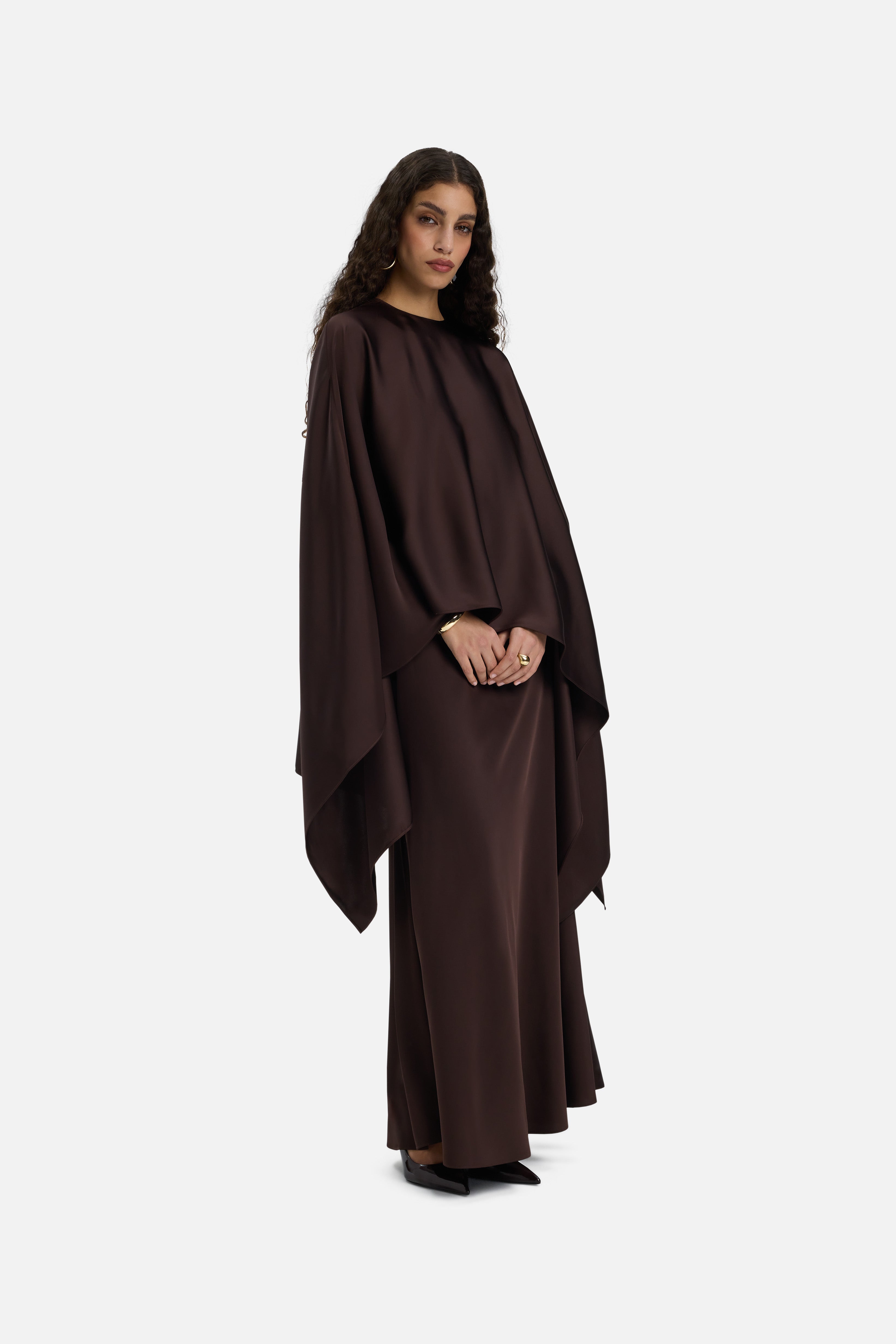 Side view model wearing asymmetric dark brown blouse