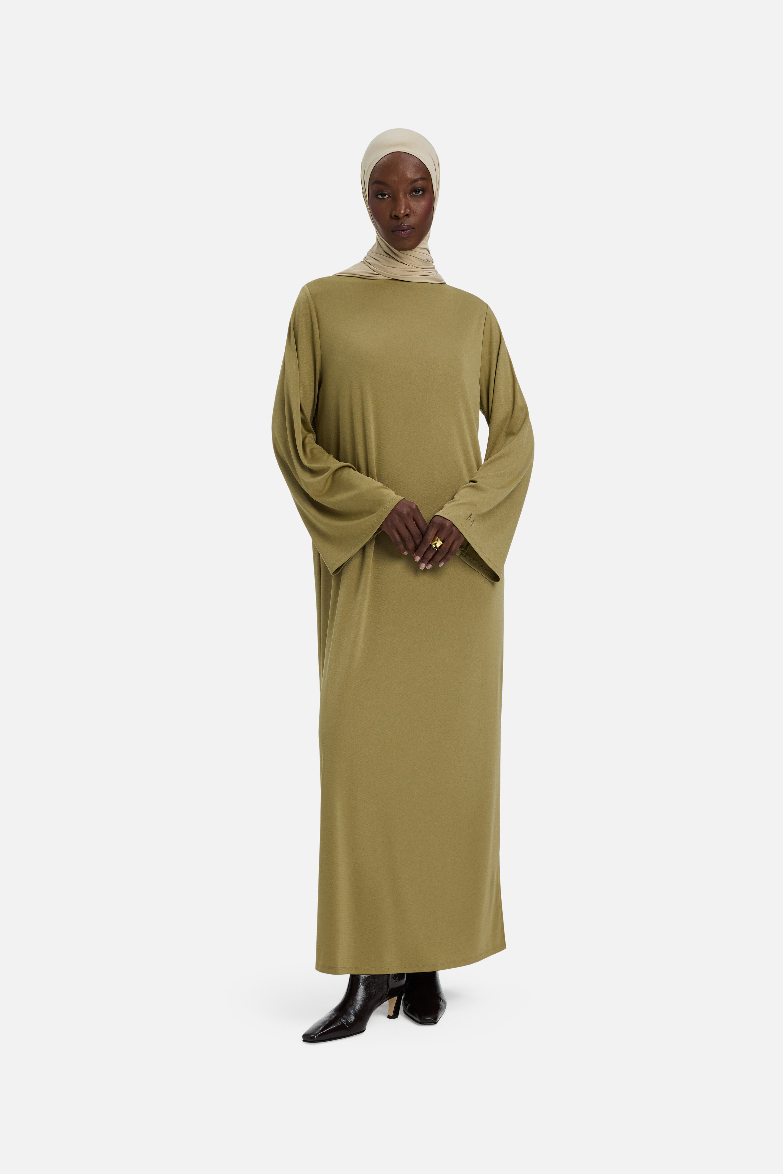 Front view model wearing green dress and headscarf