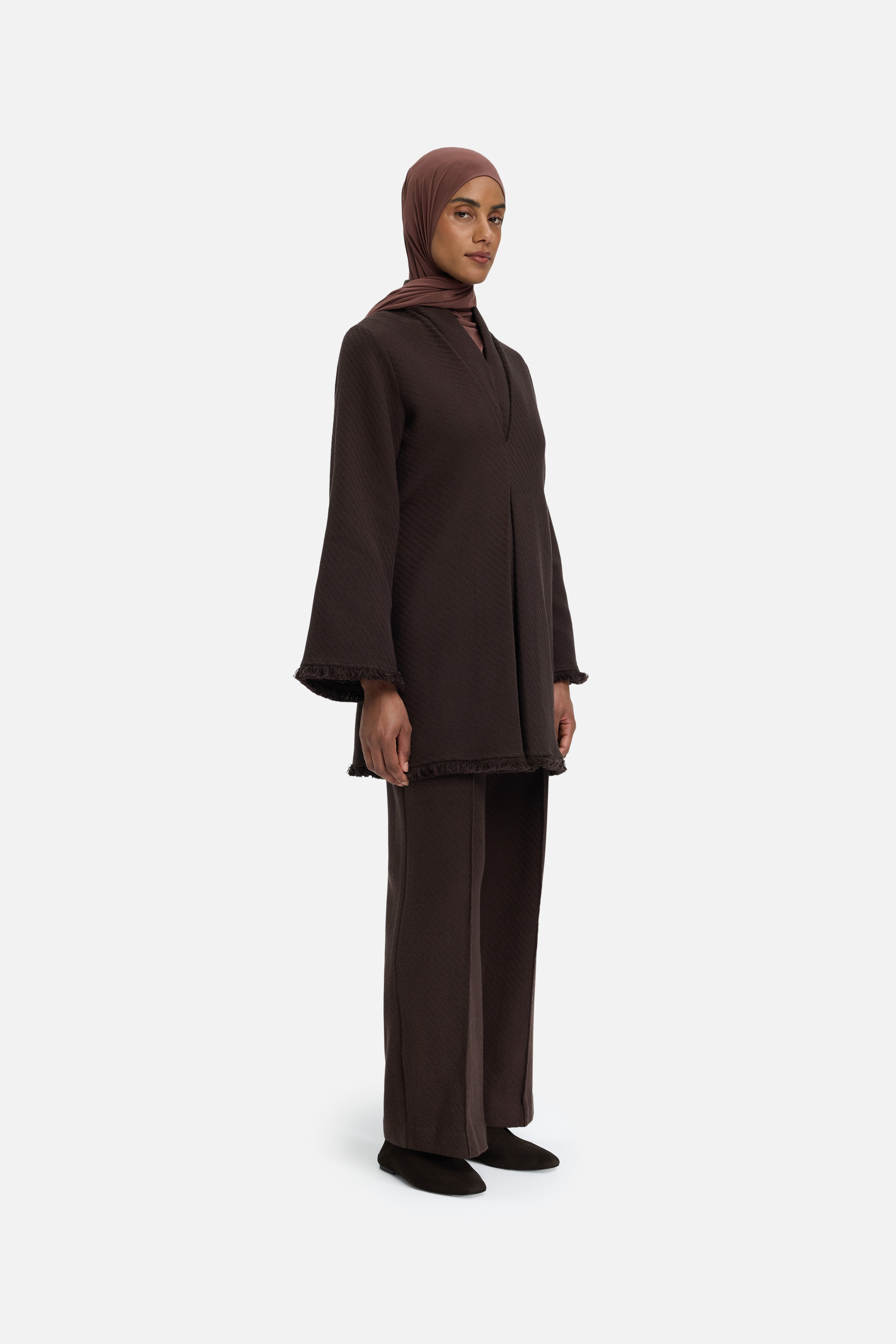 Side view model wearing dark brown top and headscarf