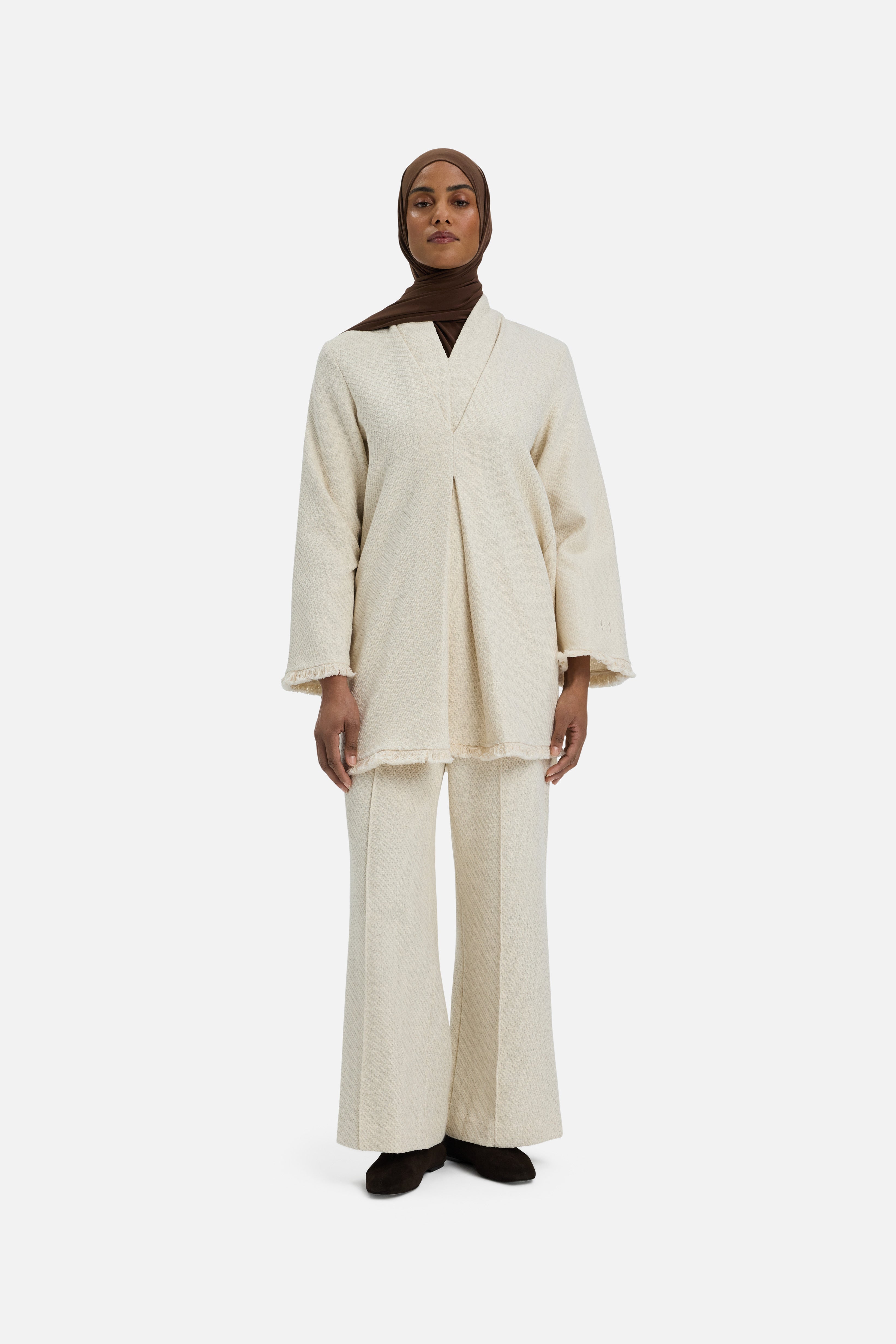 Front view model wearing white top and brown headscarf