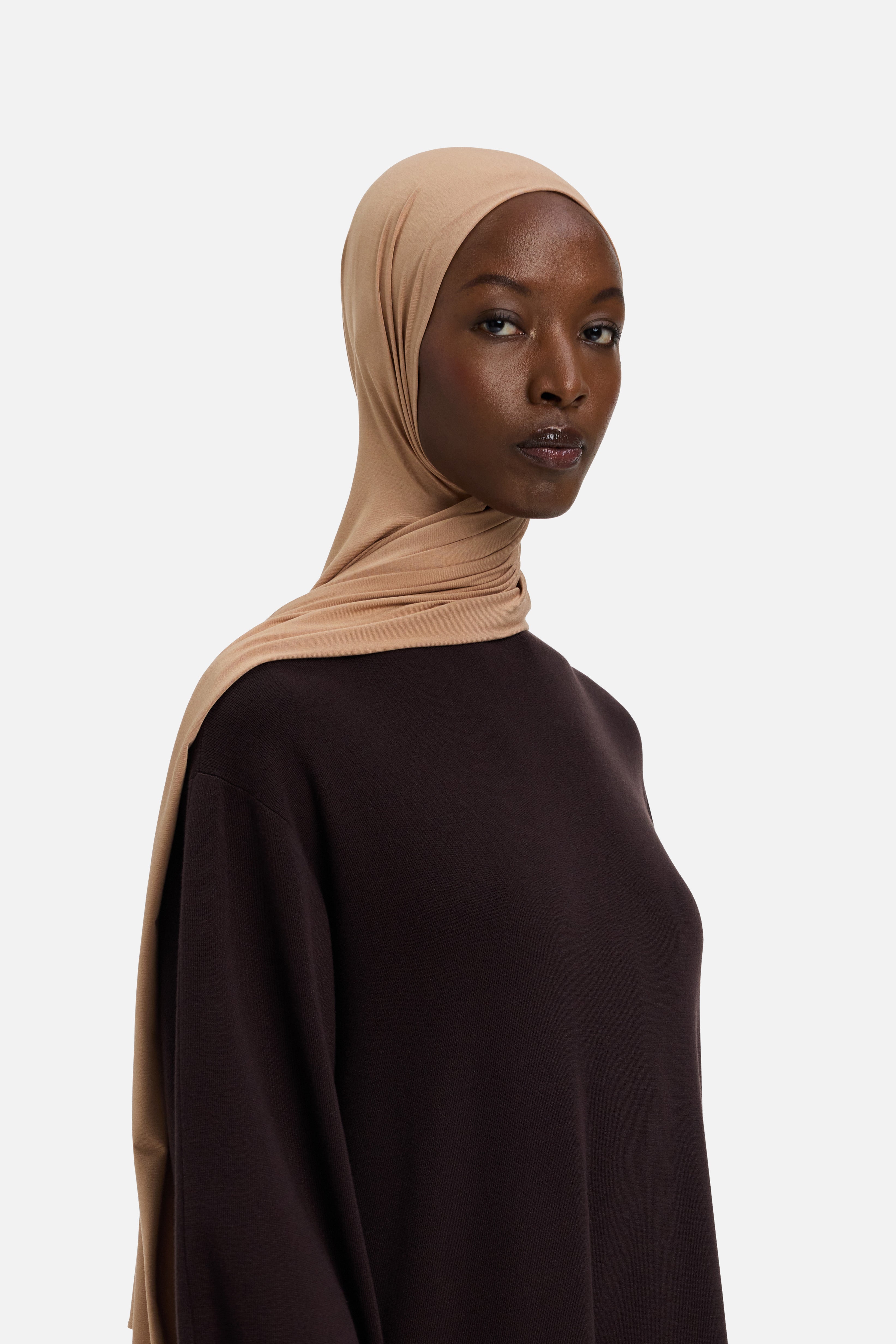 Model wearing beige MERRACHI headscarf, side view