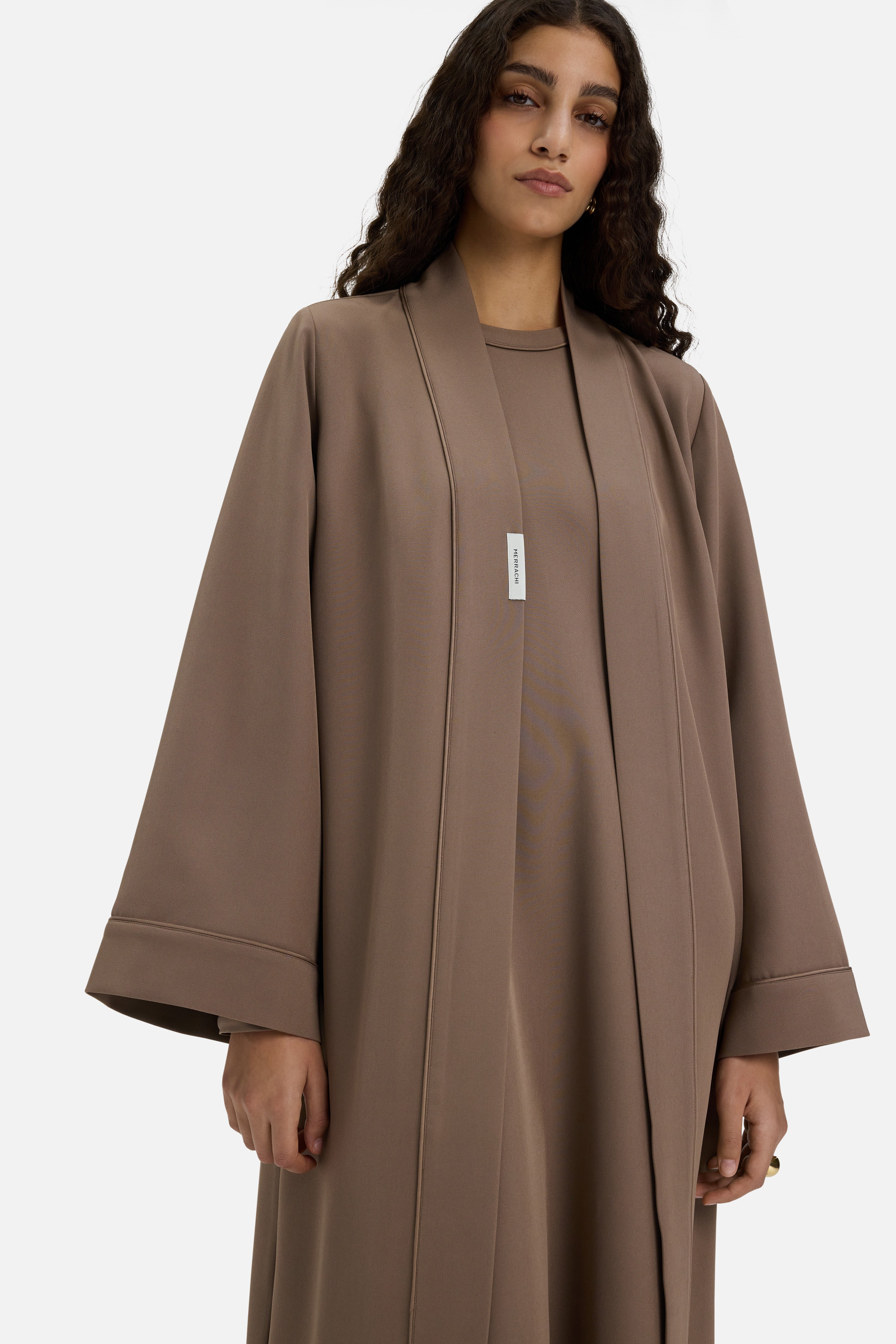 Close up view model wearing taupe abaya