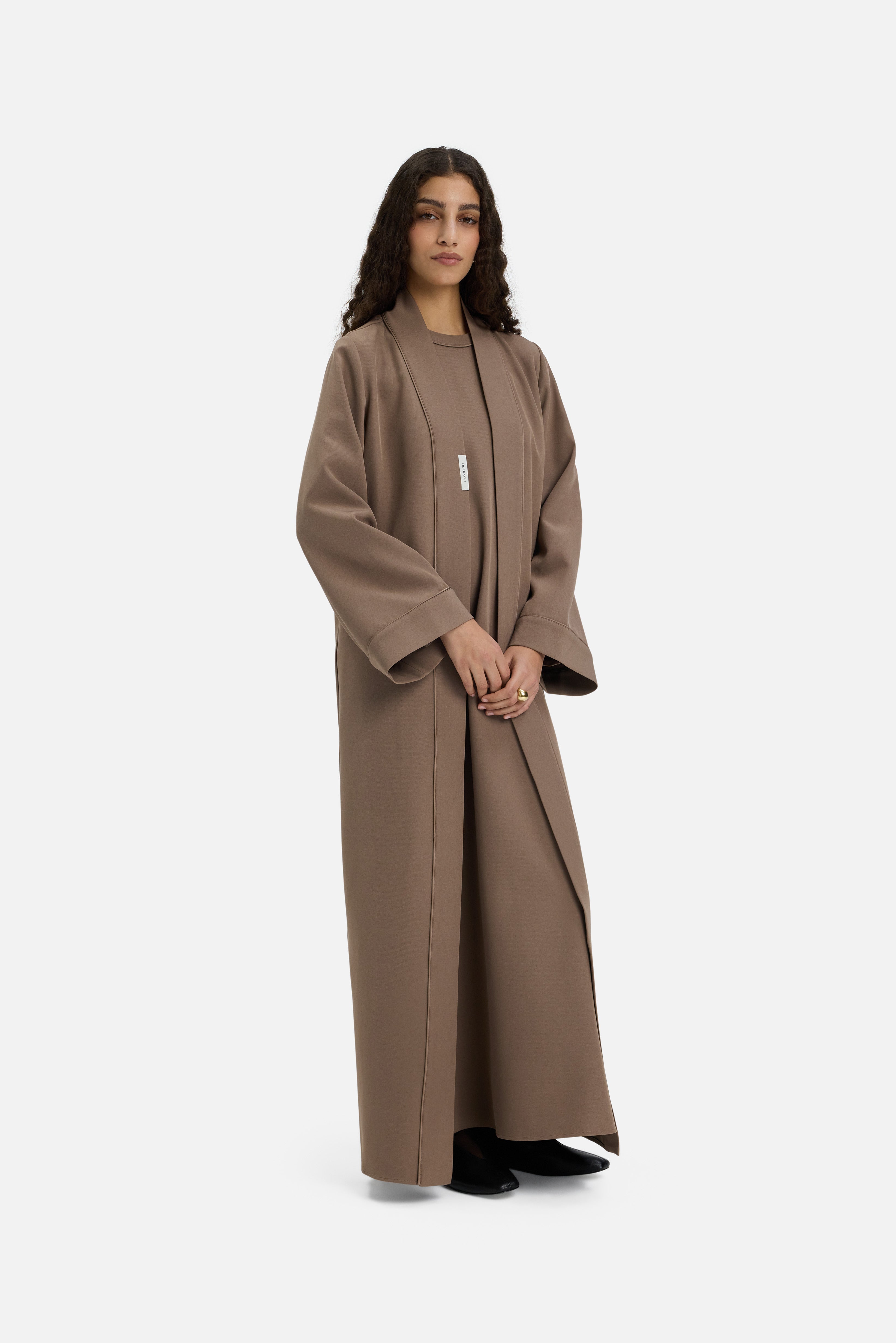 Side view model wearing taupe abaya