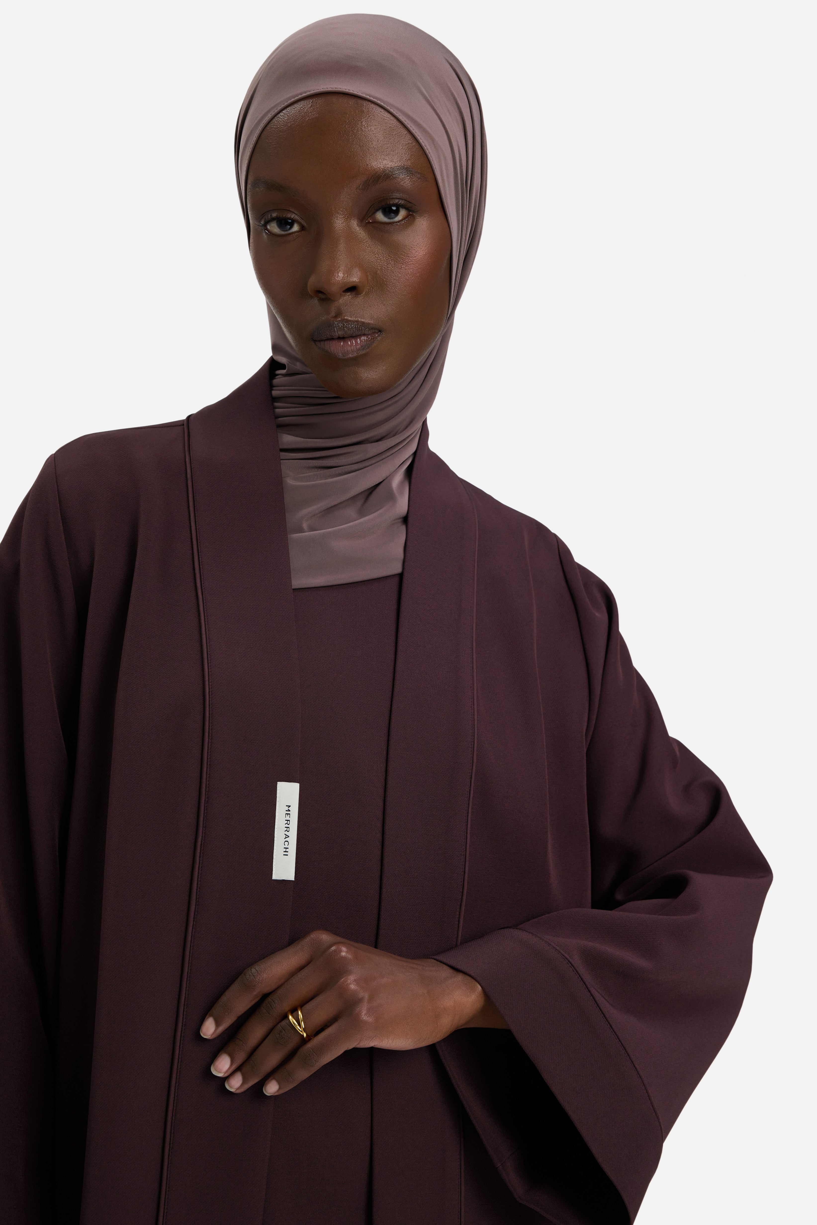Detail shot model wearing purple MERRACHI abaya and headscarf