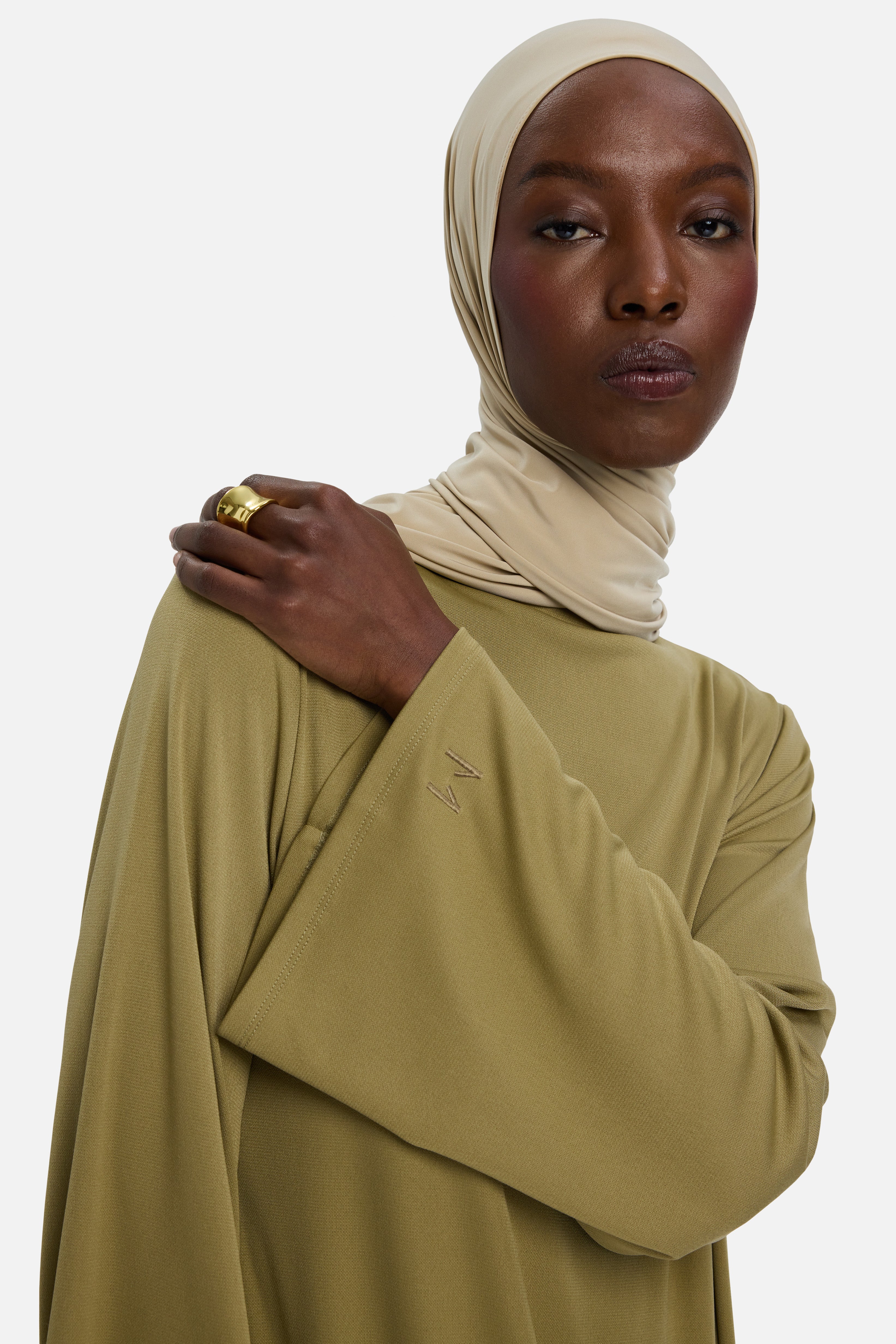 Model wearing green MERRACHI dress and headscarf