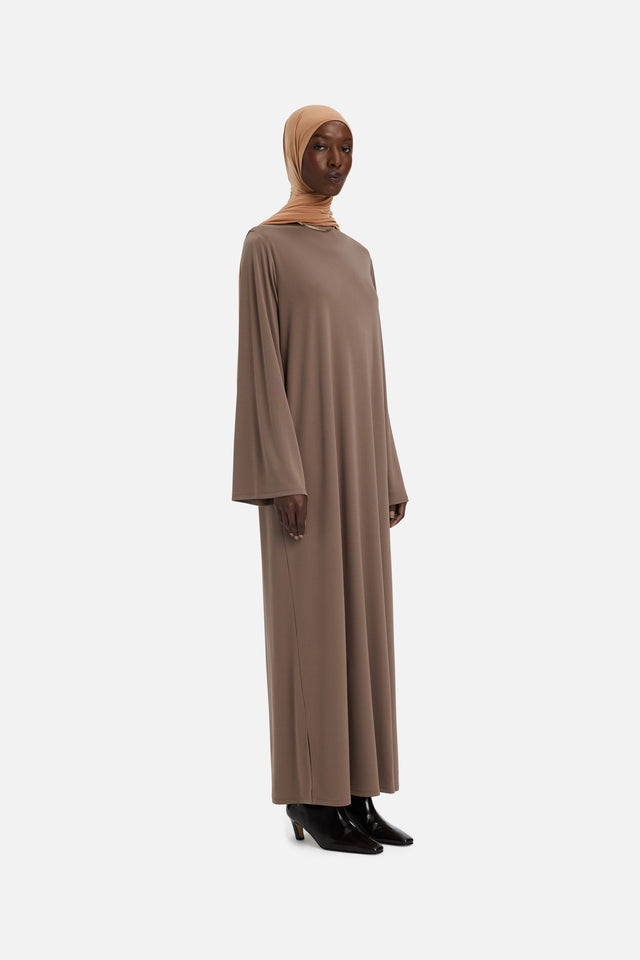 Front view model wearing taupe dress and orange headscarf