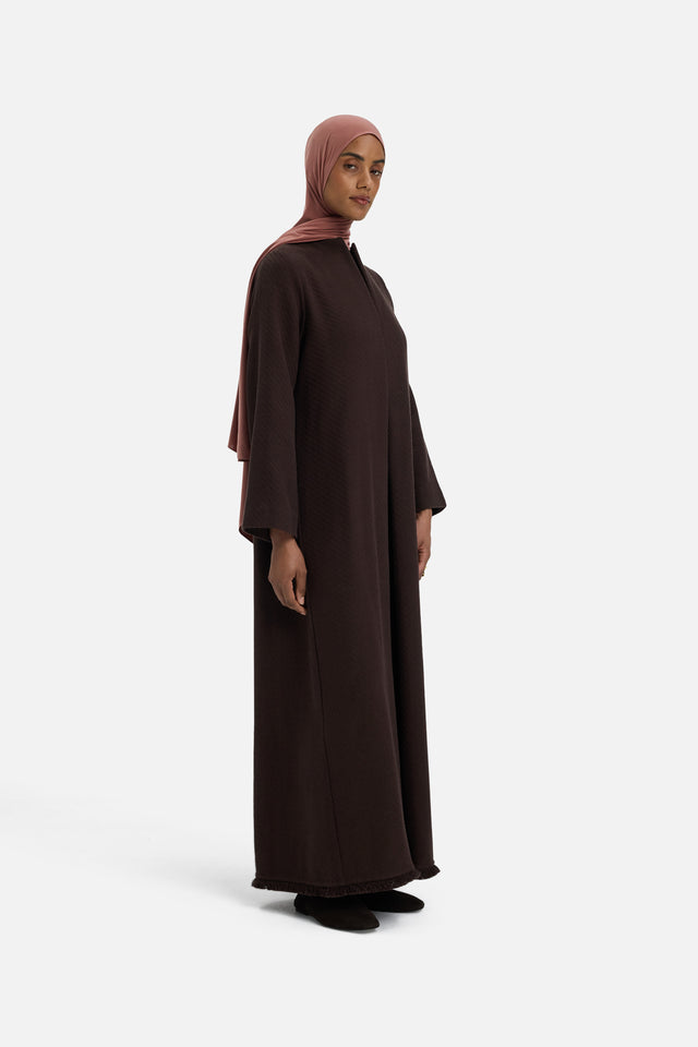 Front view model wearing dark brown dress and pink headscarf