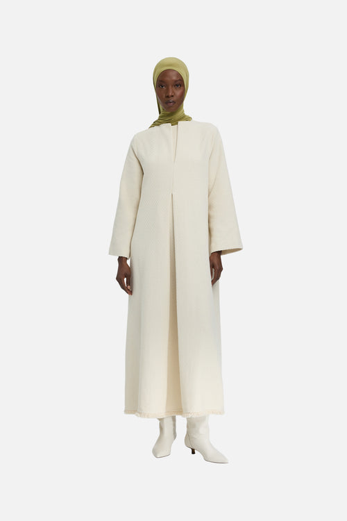 Front view model wearing off white dress and green headscarf