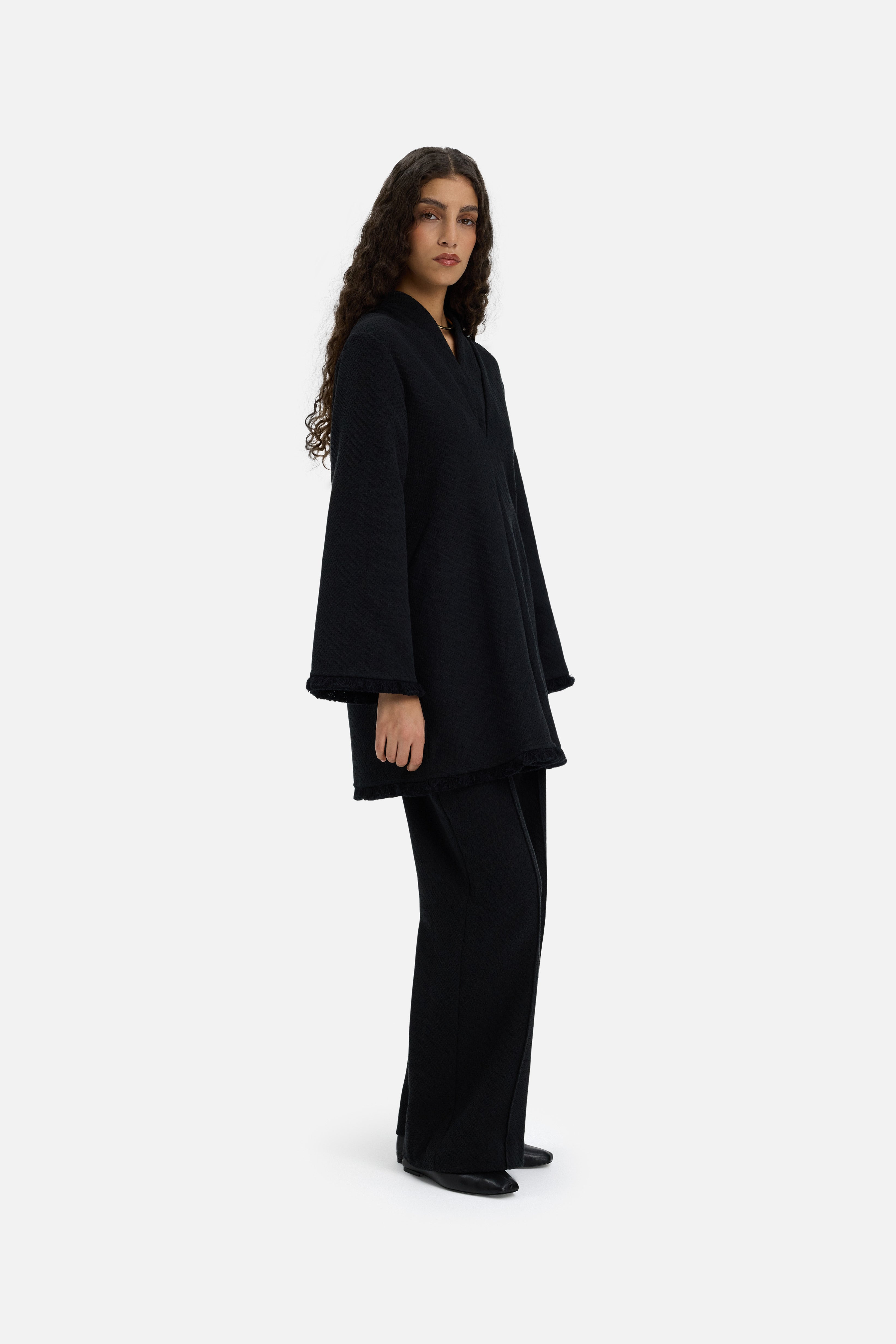 Side view model wearing black trousers