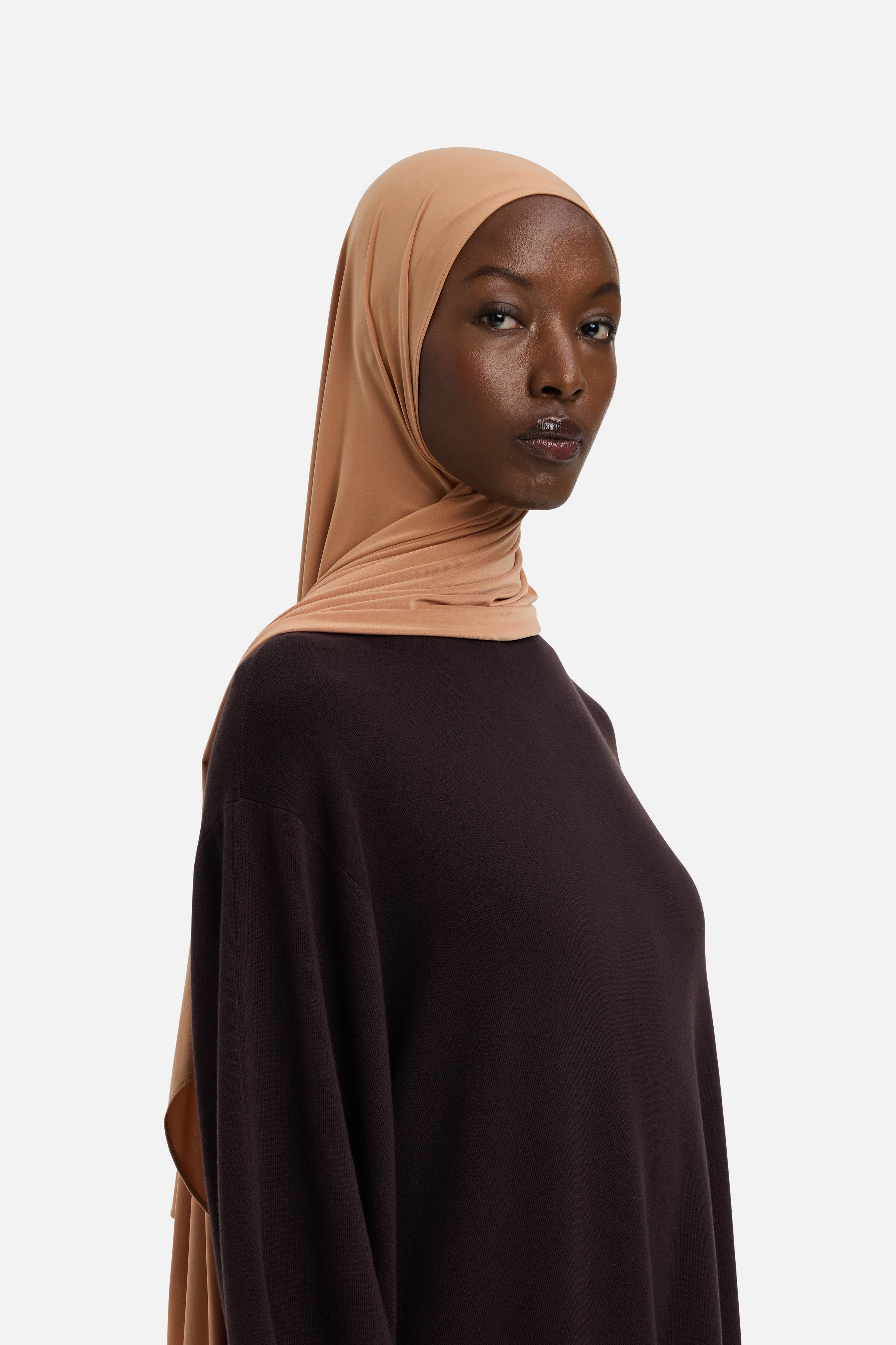 Model wearing orange MERRACHI headscarf, side view
