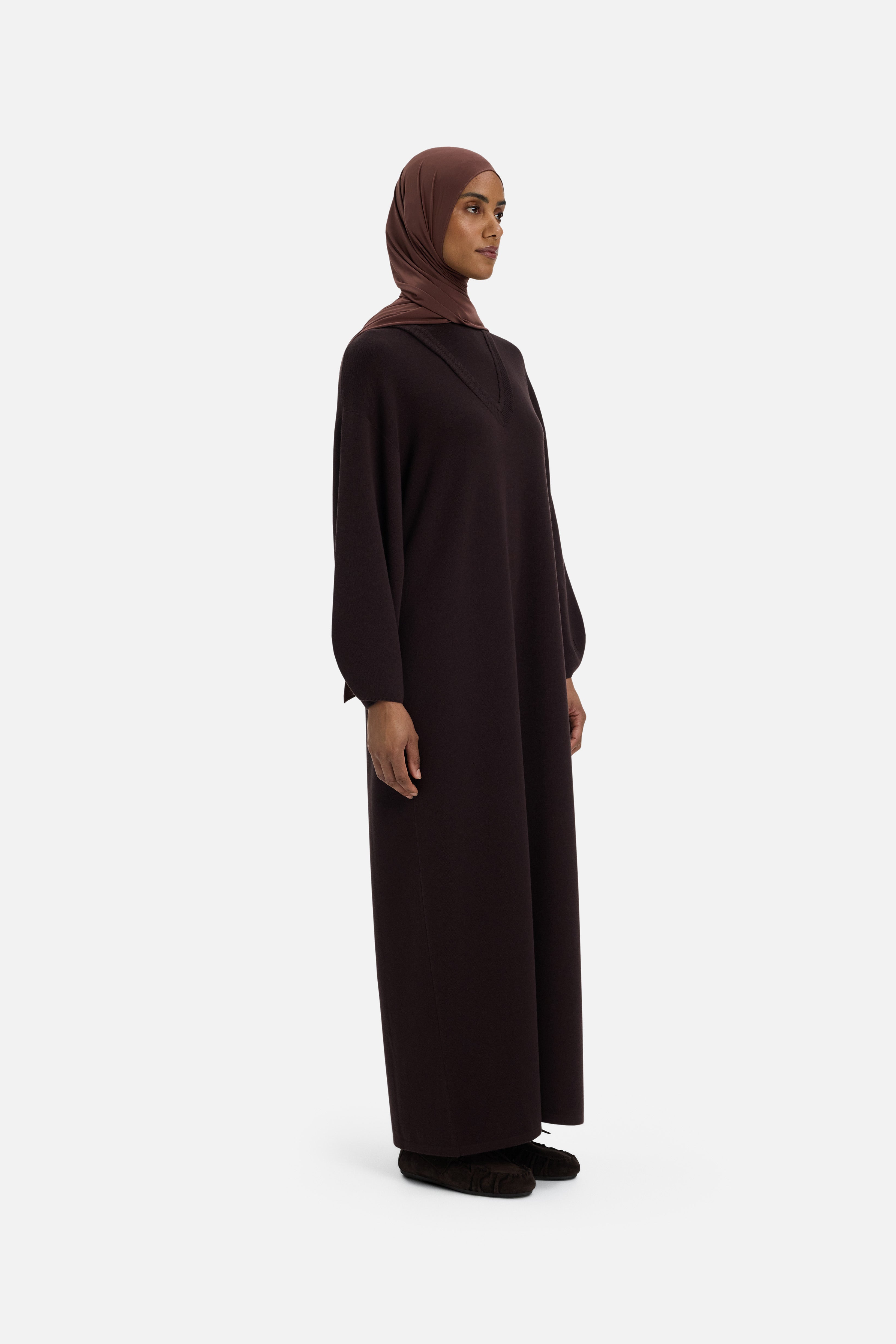 Side view model wearing long brown dress and headscarf