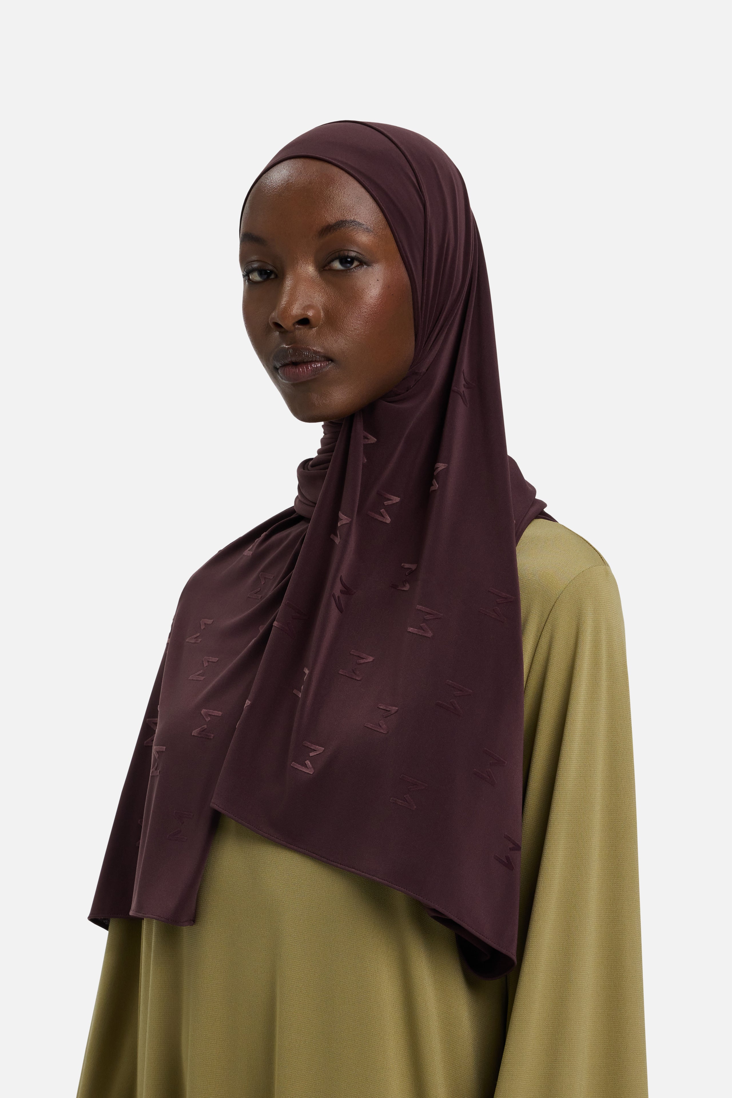 Model wearing purple headscarf MERRACHI logo embroidery, front view
